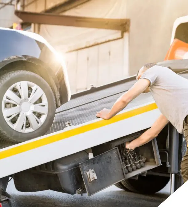Car being loaded onto tow truck.